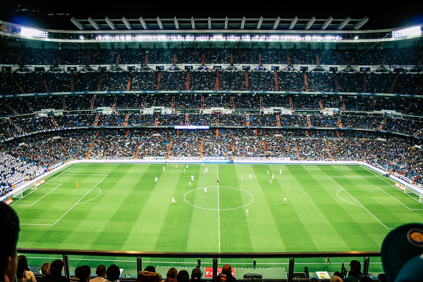 A football pitch surrounded by stadium stands
